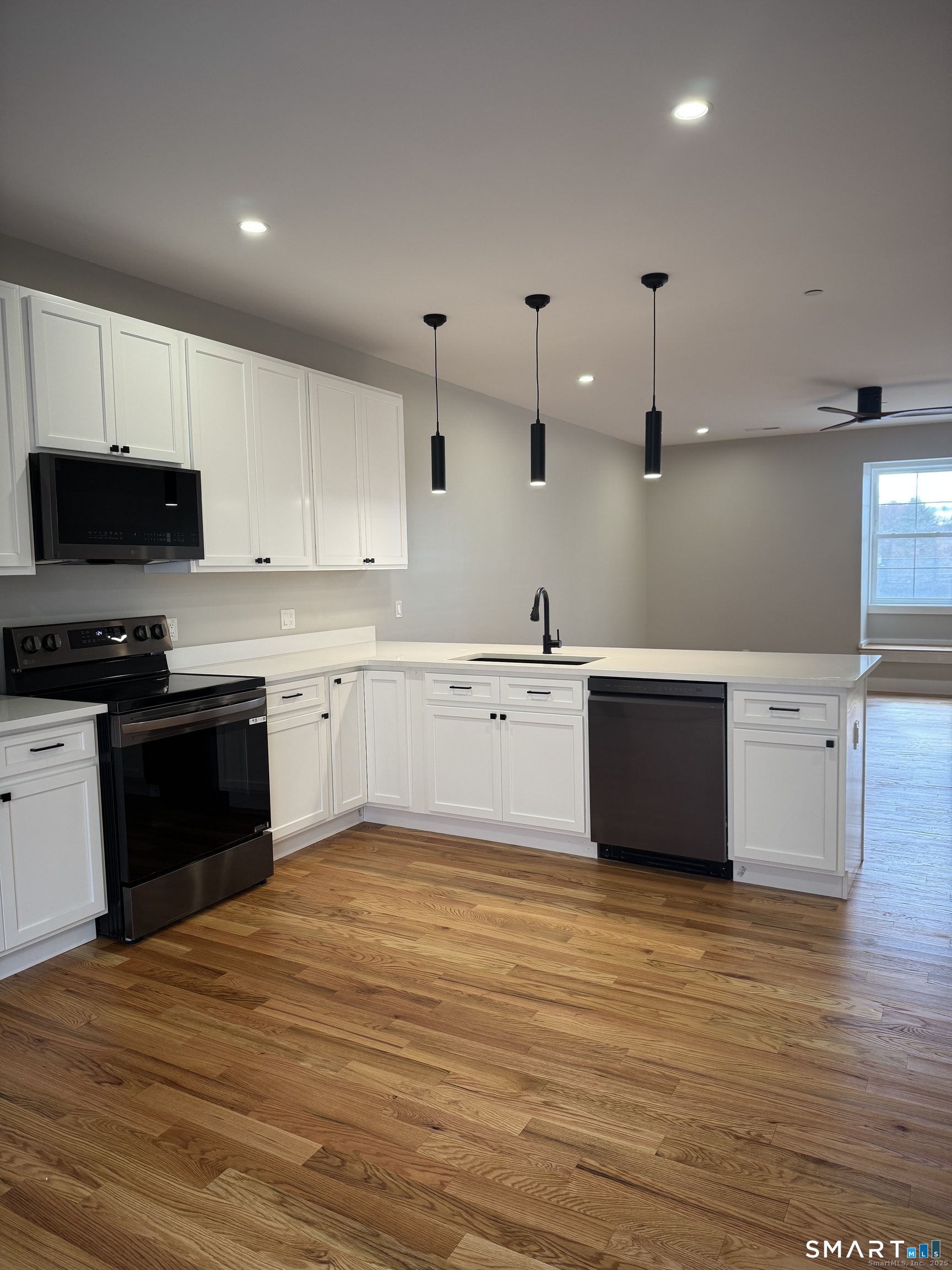 243 Echo Lake Road, Unit B12 Watertown, CT 06795 - Photo 5 of 11 a large kitchen with stainless steel appliances granite countertop a stove a sink and a refrigerator