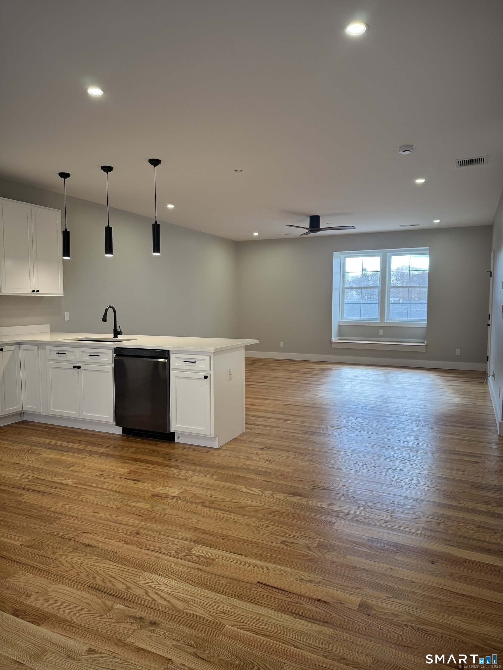 243 Echo Lake Road, Unit B12 Watertown, CT 06795 - Photo 6 of 11 a view of a kitchen with stainless steel appliances granite countertop a sink cabinets and wooden floor