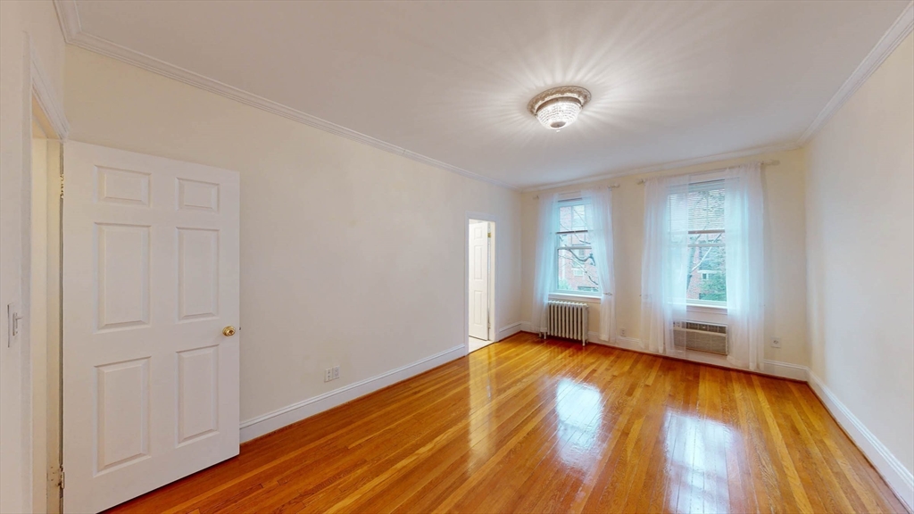 311 Tappan Street, Unit 3 Brookline, MA 02445 - Photo 27 of 35 a view of empty room with wooden floor and fan
