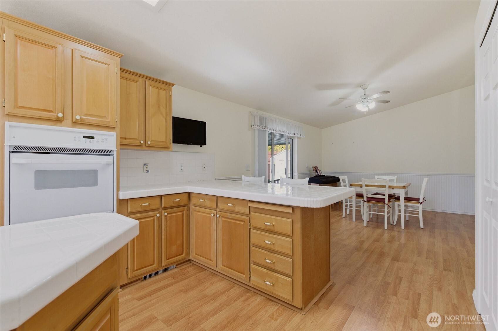 24036 222nd Avenue Southeast Maple Valley, WA 98038 - Photo 11 of 37 a kitchen with a sink cabinets and wooden floor