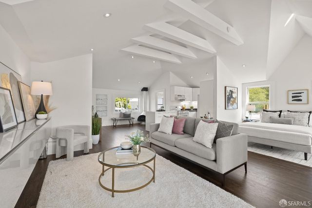 a bedroom with bed a mirror and a large window