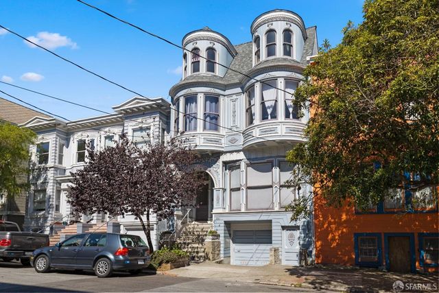a couple of cars parked in front of a building