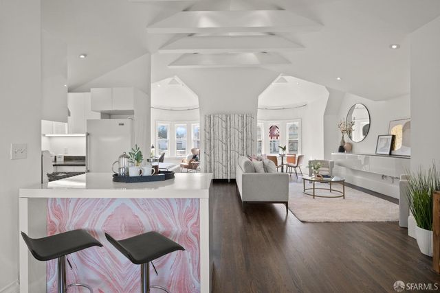 a living room with fireplace furniture and wooden floor