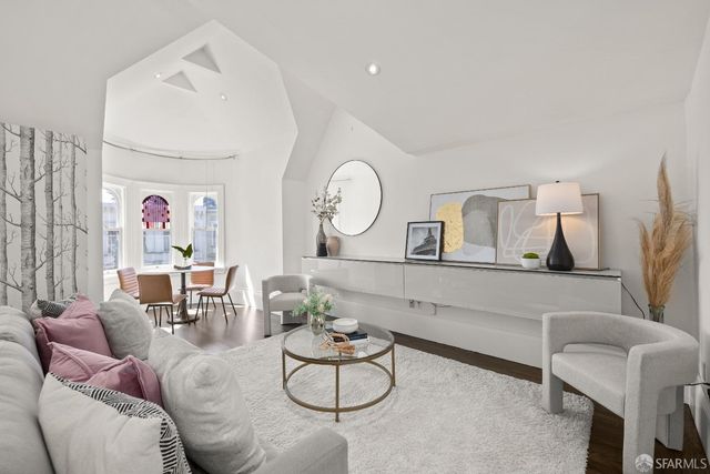 a living room with furniture and a mirror