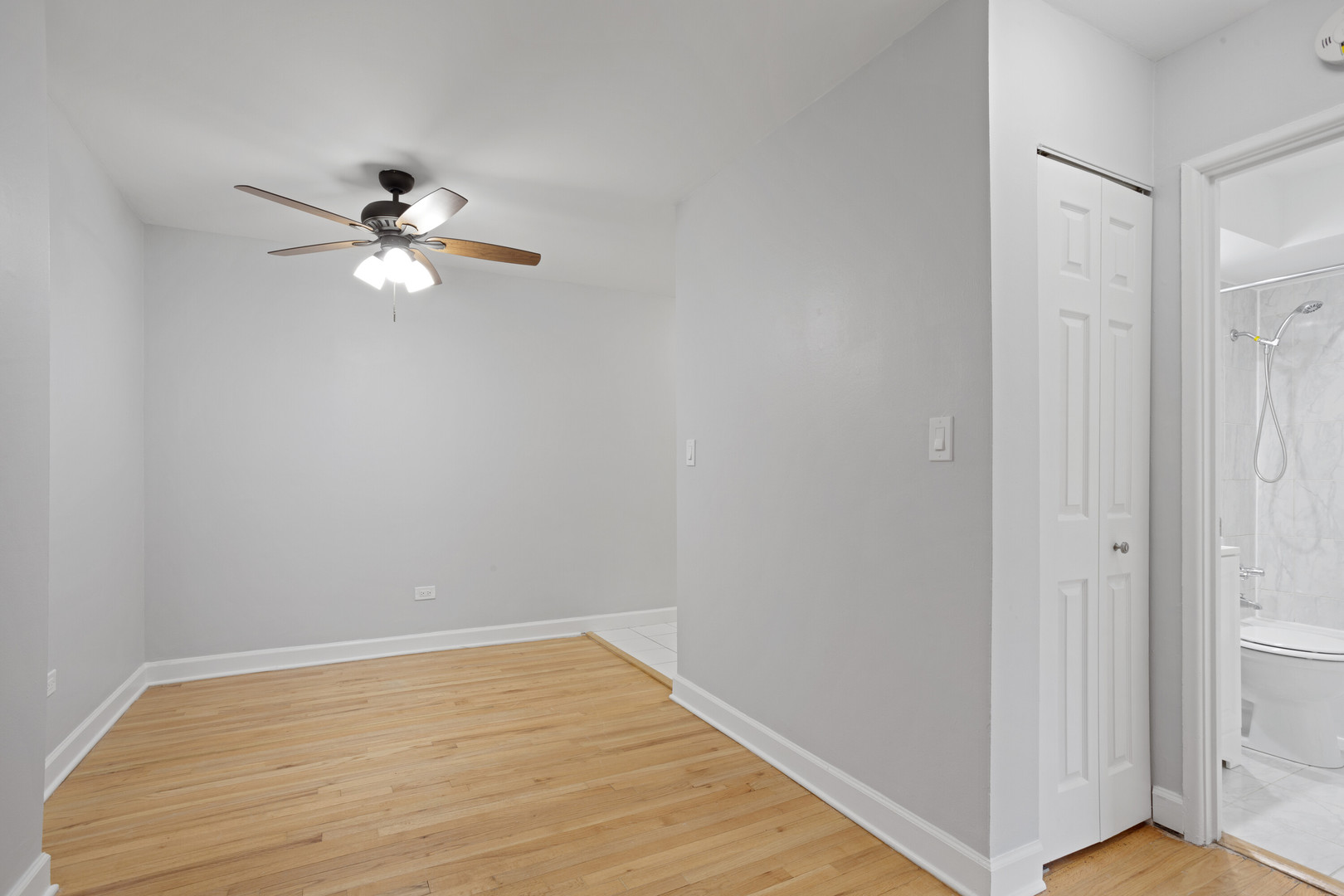6758 North Sheridan Road, Unit 232 Chicago, IL 60626 - Photo 8 of 12 a view of empty room with wooden floor