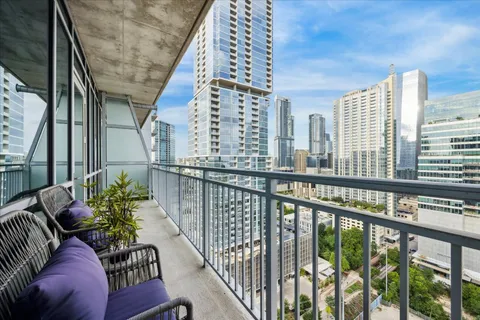 a living room with furniture kitchen and a large window