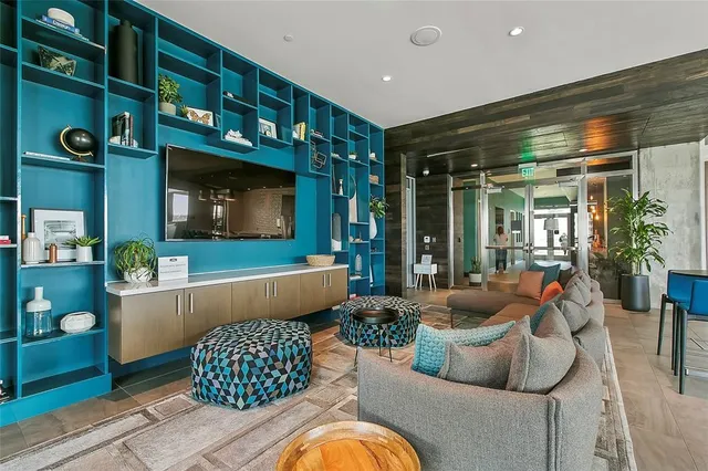 a view of a swimming pool with a couch and wooden floor