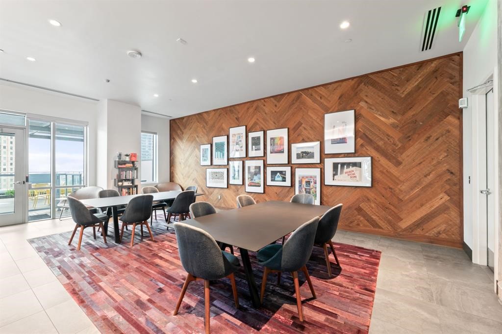 222 West Avenue, Unit 2403 Austin, TX 78701 - Photo 30 of 38 a dining room with furniture a rug and wooden floor