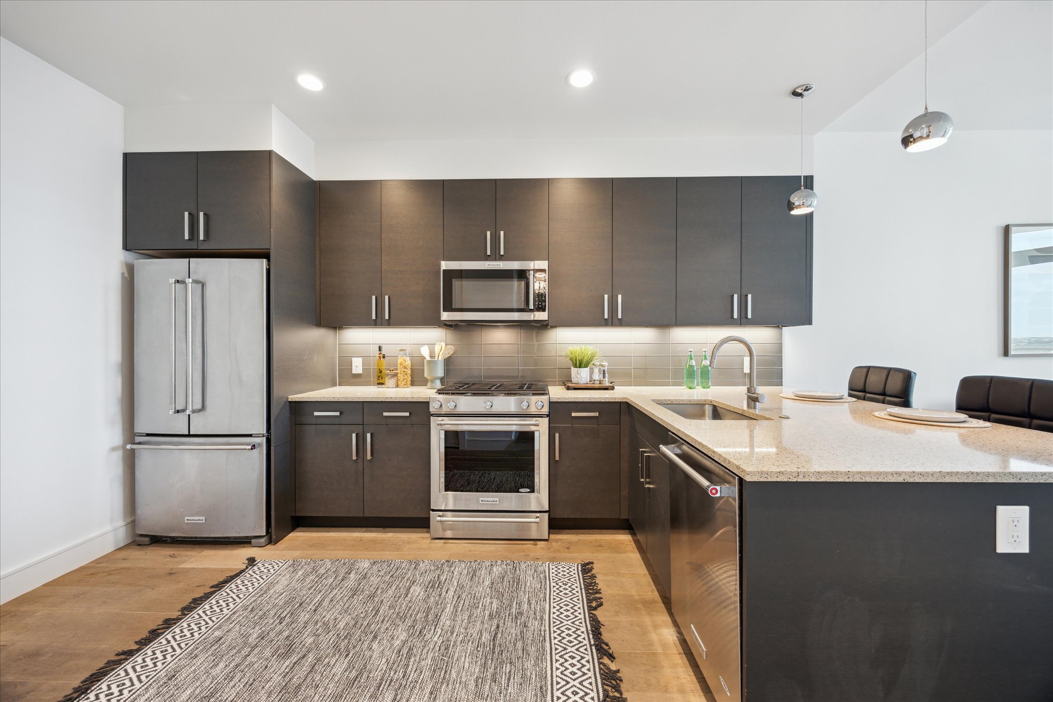 222 West Avenue, Unit 2403 Austin, TX 78701 - Photo 2 of 38 a kitchen with kitchen island granite countertop a sink stove and refrigerator