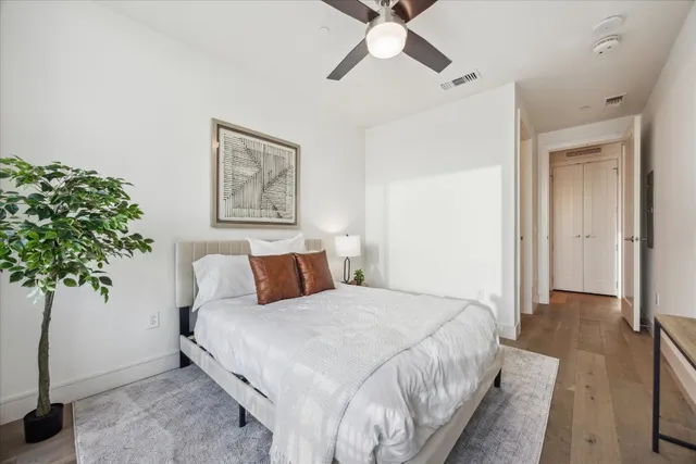 a living room with furniture kitchen and a large window