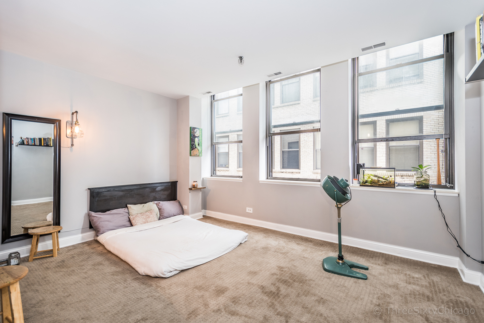 640 South Federal Street, Unit 504 Chicago, IL 60605 - Photo 2 of 13 a bedroom with a bed and wooden floor