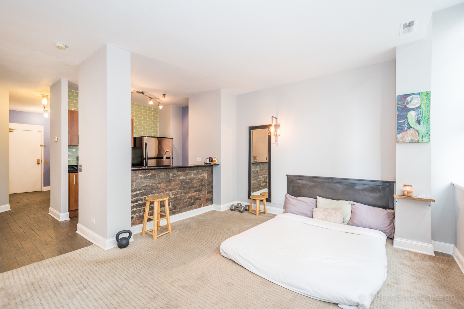 640 South Federal Street, Unit 504 Chicago, IL 60605 - Photo 4 of 13 a bedroom with a large bed and a couch