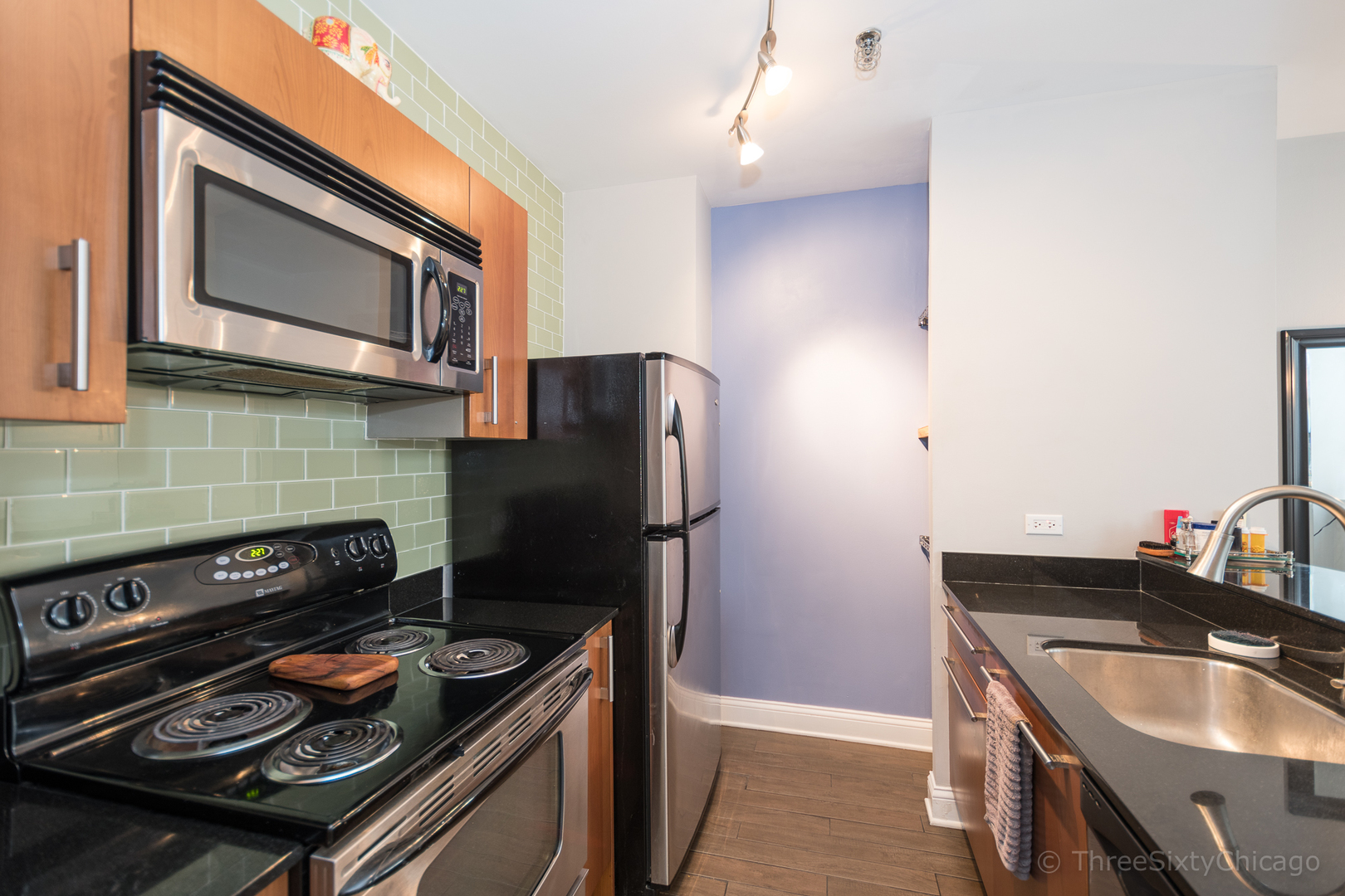 640 South Federal Street, Unit 504 Chicago, IL 60605 - Photo 6 of 13 a kitchen with a stove and a microwave