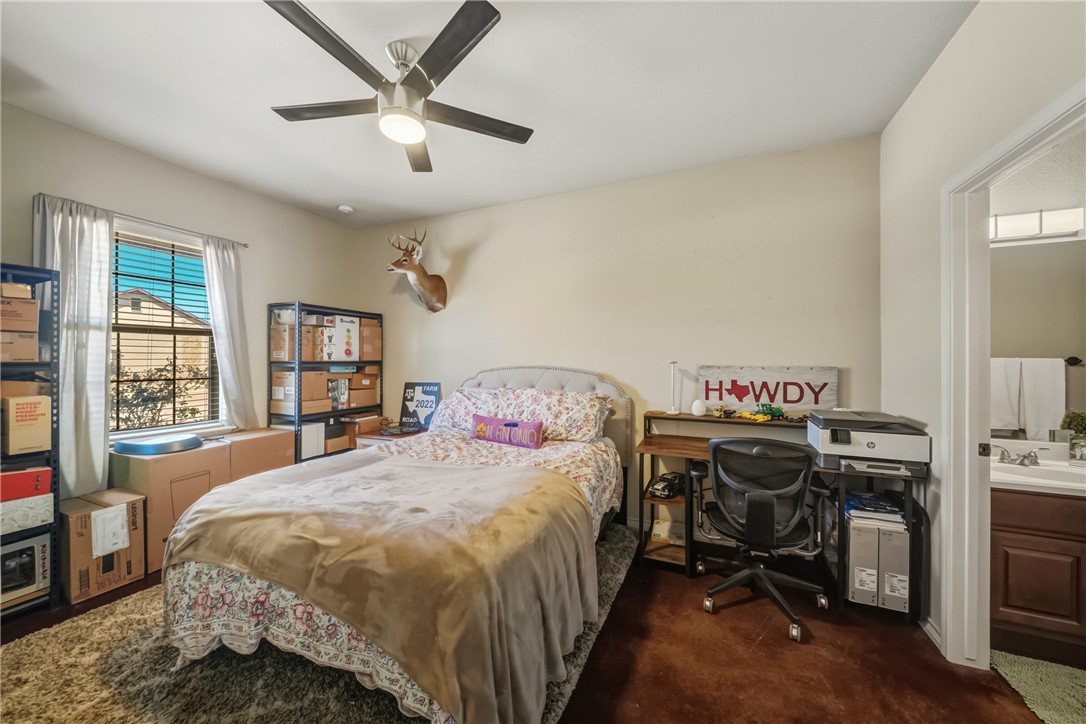 3205 Corporal Road College Station, TX 77845 - Photo 16 of 29 a bedroom with a bed and a chandelier