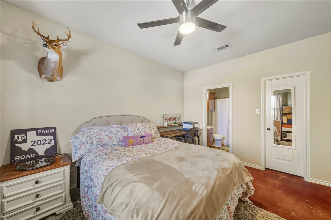 3205 Corporal Road College Station, TX 77845 - Photo 17 of 29 a bedroom with a bed and a chandelier