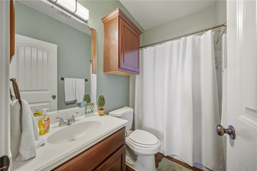 3205 Corporal Road College Station, TX 77845 - Photo 18 of 29 a bathroom with a sink a toilet and shower curtain