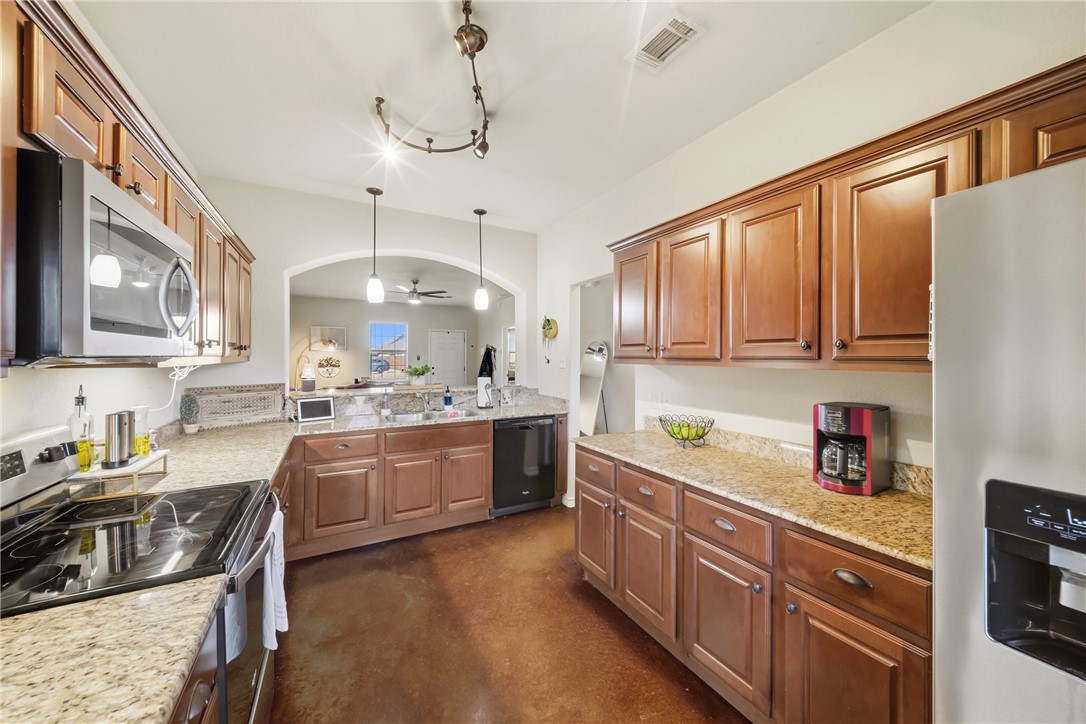 3205 Corporal Road College Station, TX 77845 - Photo 9 of 29 a kitchen with stainless steel appliances a stove sink and cabinets