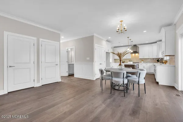 a kitchen with a table chairs sink and cabinets
