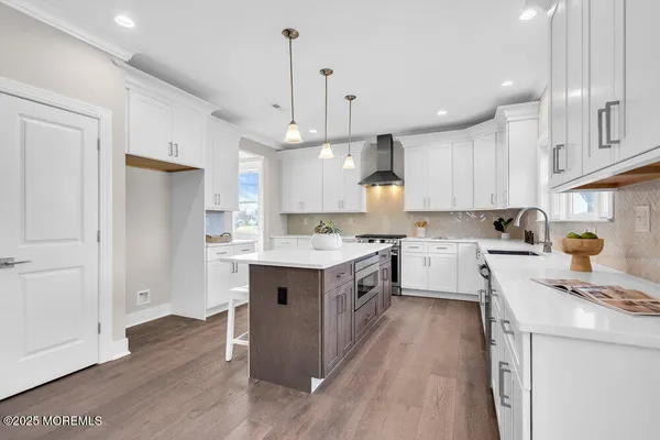 a kitchen that has a lot of cabinets in it with a dining table and chairs
