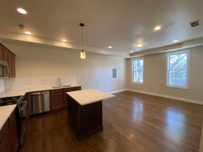 1734 West 35th Street, Unit 2F Chicago, IL 60609 - Photo 3 of 7 a kitchen with stainless steel appliances granite countertop a sink a stove and a wooden floors