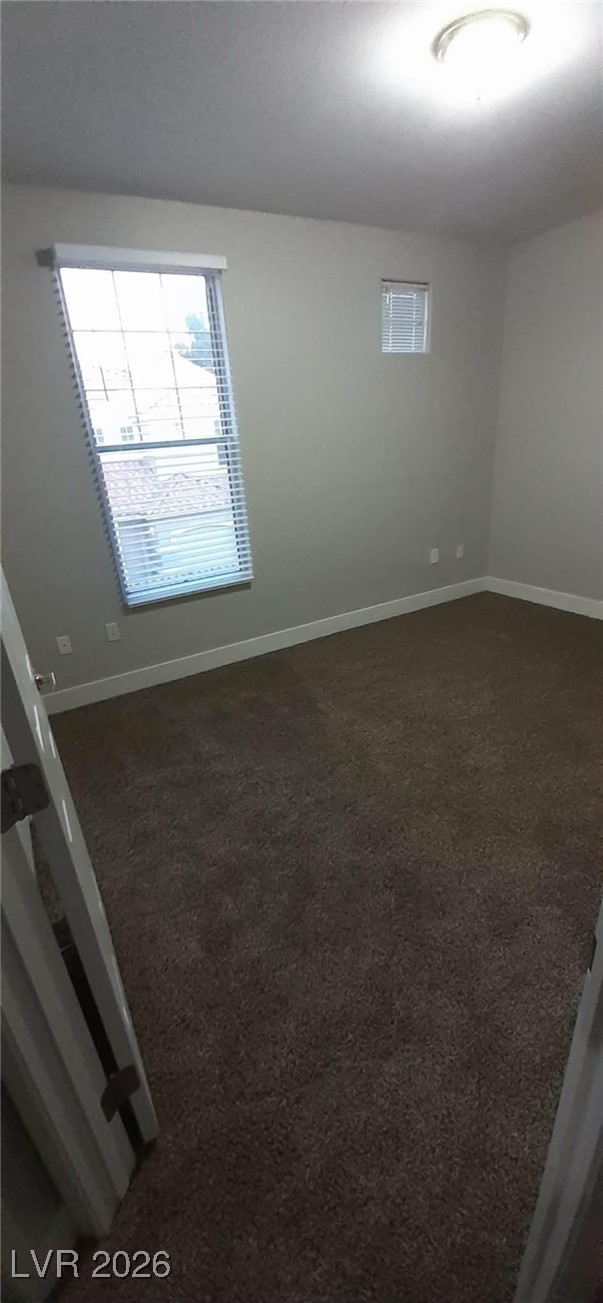 8555 West Russell Road, Unit 2018 Las Vegas, NV 89113 - Photo 12 of 31 Spare room with dark colored carpet and baseboards