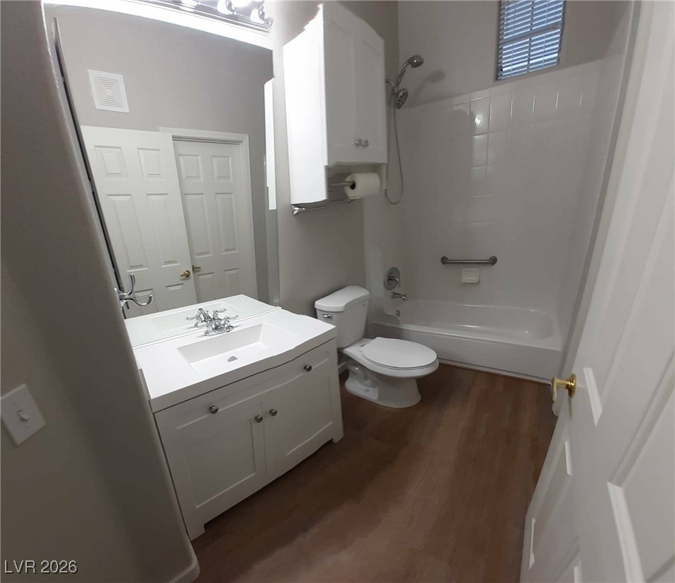 8555 West Russell Road, Unit 2018 Las Vegas, NV 89113 - Photo 13 of 31 Full bathroom featuring vanity, dark wood-style flooring, and bathing tub / shower combination