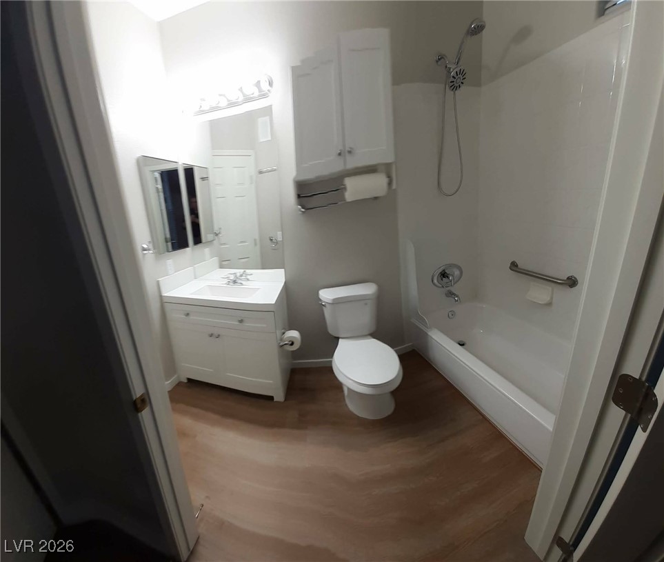 8555 West Russell Road, Unit 2018 Las Vegas, NV 89113 - Photo 14 of 31 Full bathroom with vanity, shower / washtub combination, and dark wood-type flooring
