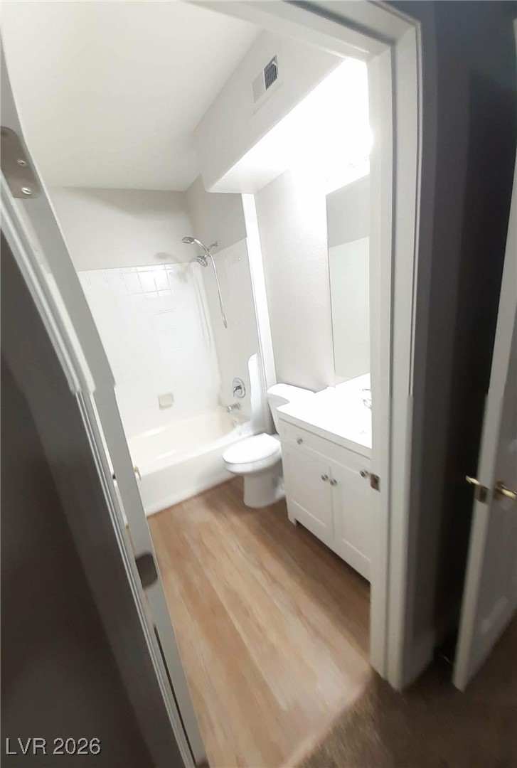 8555 West Russell Road, Unit 2018 Las Vegas, NV 89113 - Photo 16 of 31 Bathroom featuring vanity, shower combination, and dark wood finished floors