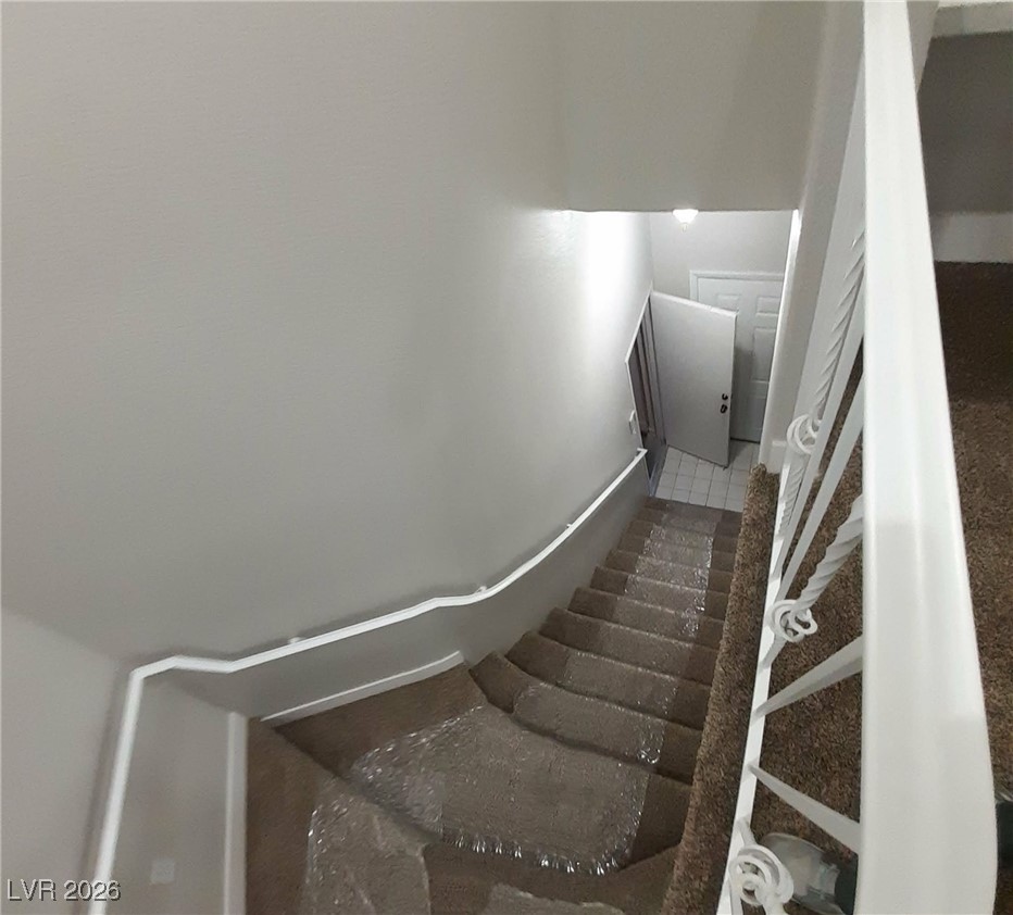 8555 West Russell Road, Unit 2018 Las Vegas, NV 89113 - Photo 22 of 31 Stairway featuring baseboards
