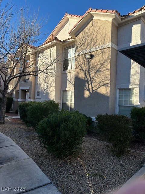 8555 West Russell Road, Unit 2018 Las Vegas, NV 89113 - Photo 4 of 31 View of home's exterior featuring stucco siding and a tile roof
