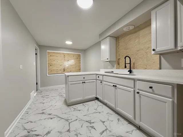 a kitchen with sink cabinets and window