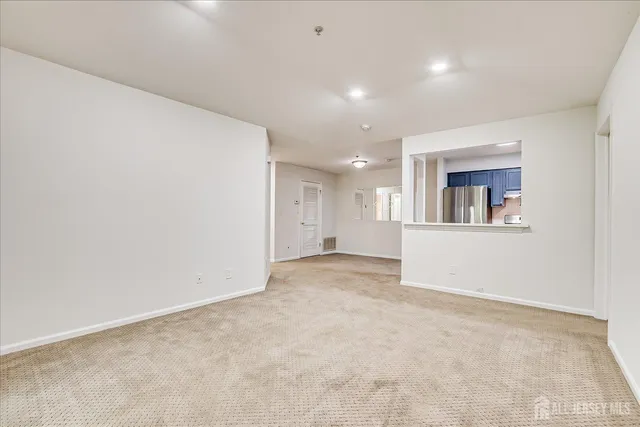 an empty room with a kitchen and a sink