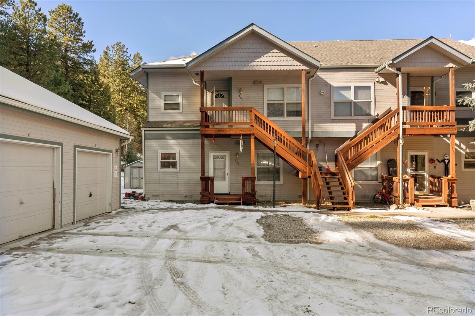 5720 County Road 64, Unit 101A Bailey, CO 80421 - Photo 1 of 46 a front view of a house with a yard