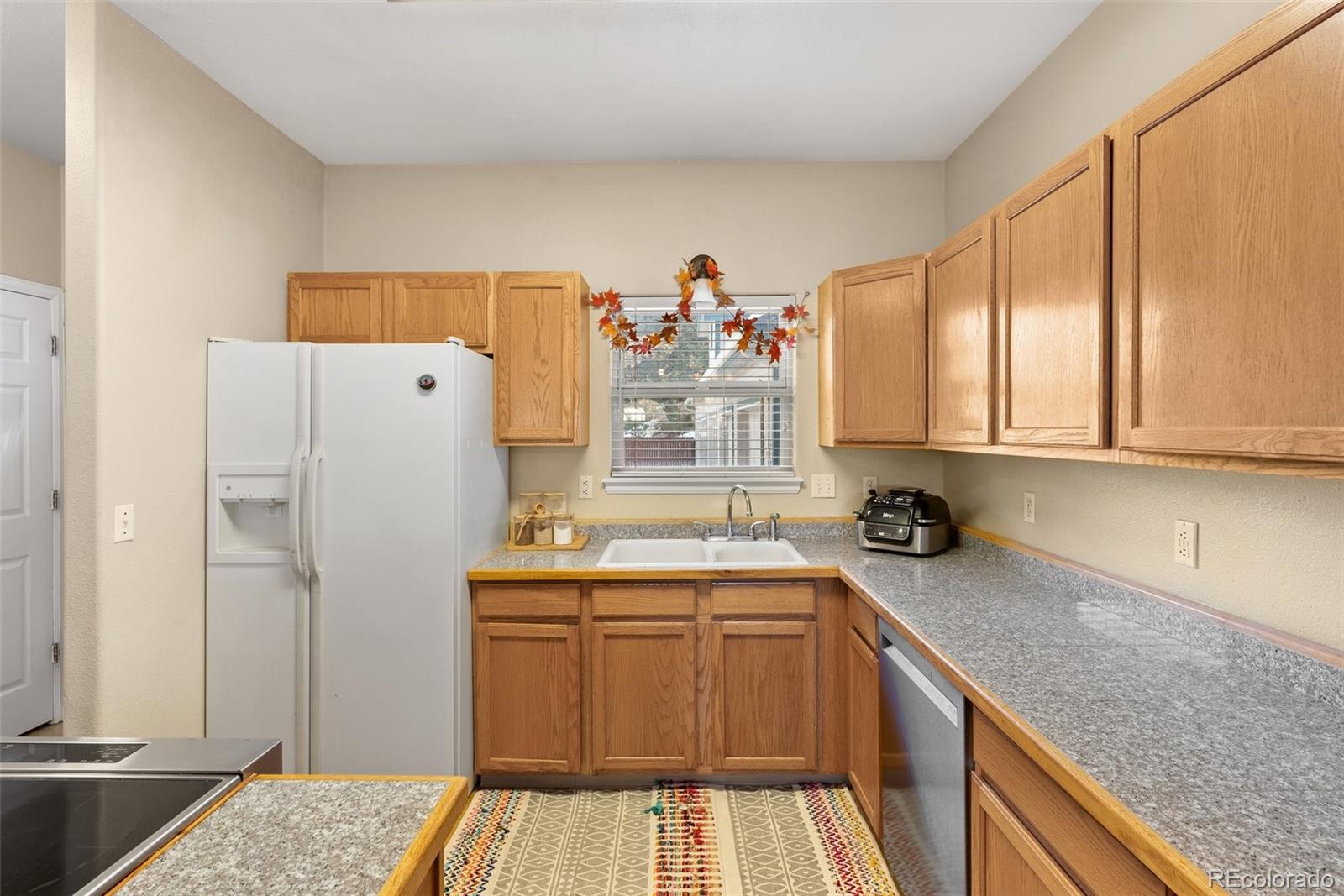 5720 County Road 64, Unit 101A Bailey, CO 80421 - Photo 11 of 46 a kitchen with a sink stove and cabinets