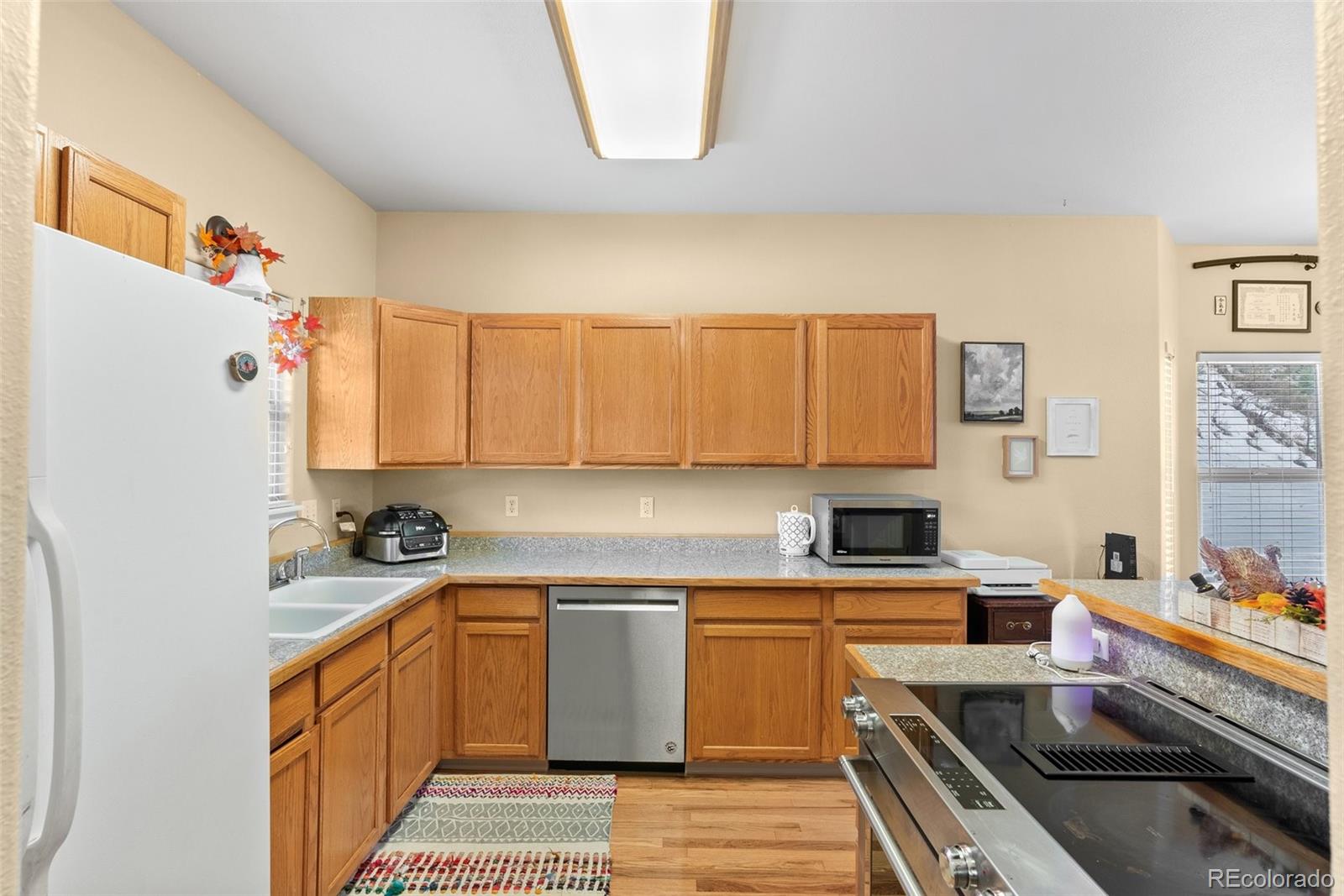 5720 County Road 64, Unit 101A Bailey, CO 80421 - Photo 13 of 46 a kitchen with a sink stove and cabinets