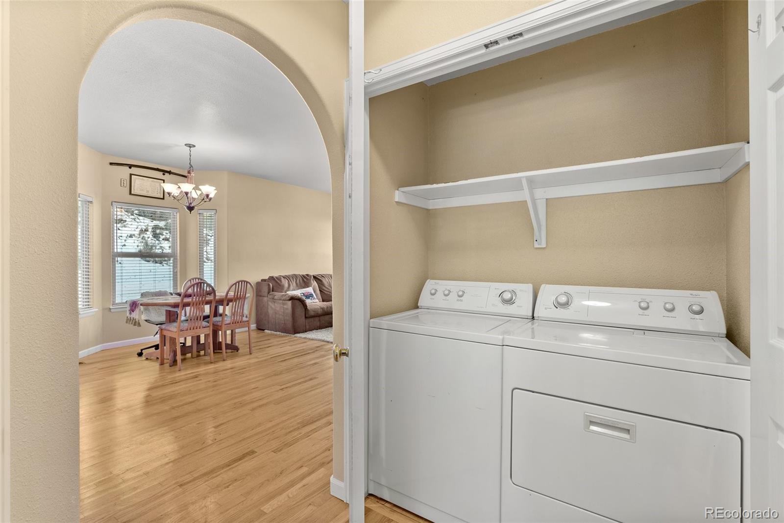 5720 County Road 64, Unit 101A Bailey, CO 80421 - Photo 21 of 46 a view of washer and dryer with kitchen in the background