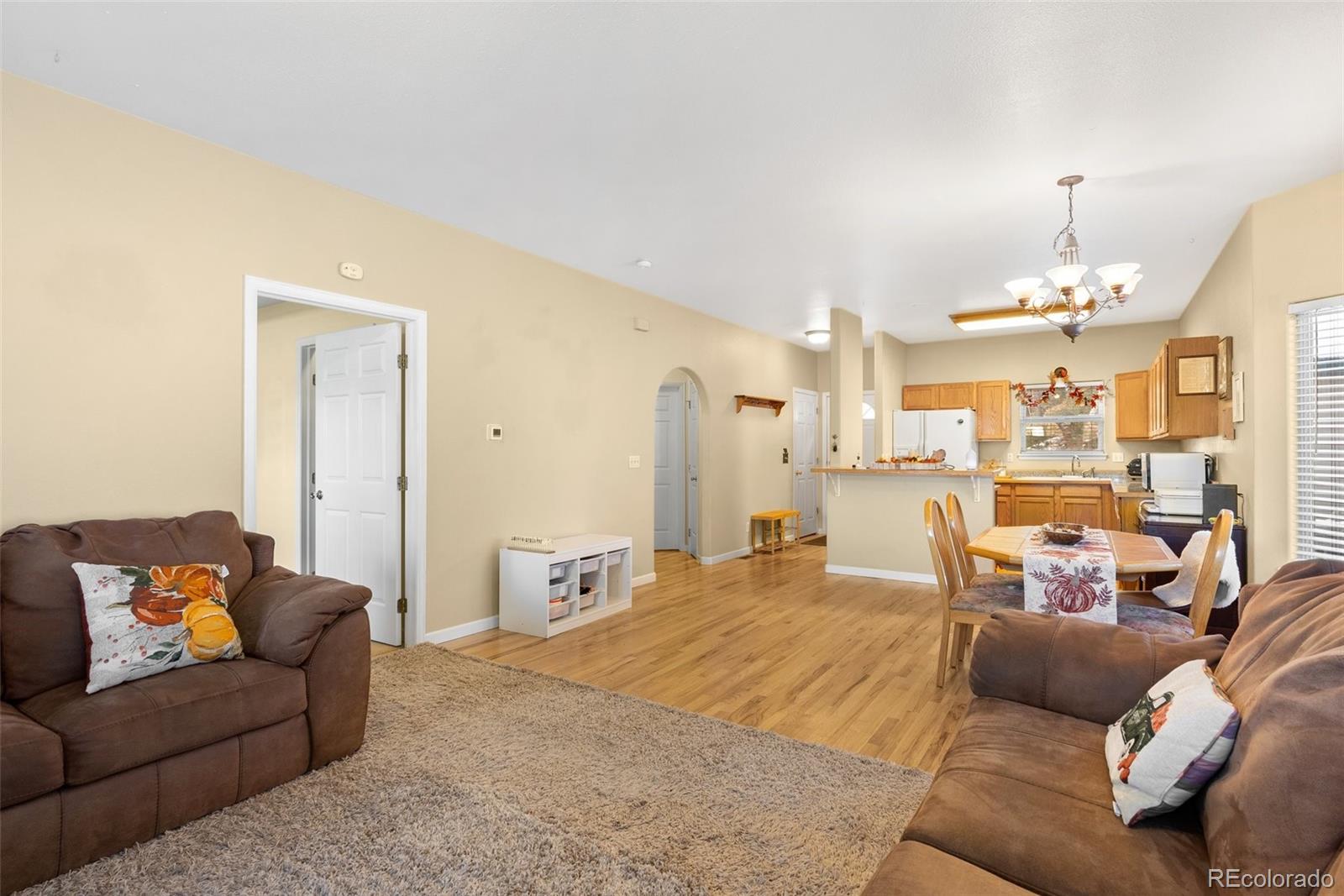 5720 County Road 64, Unit 101A Bailey, CO 80421 - Photo 6 of 46 a living room with furniture and a chandelier