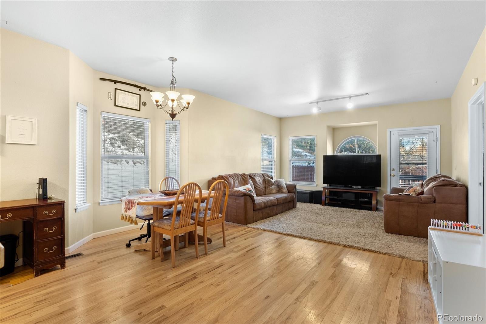 5720 County Road 64, Unit 101A Bailey, CO 80421 - Photo 8 of 46 a living room with furniture a chandelier and a flat screen tv