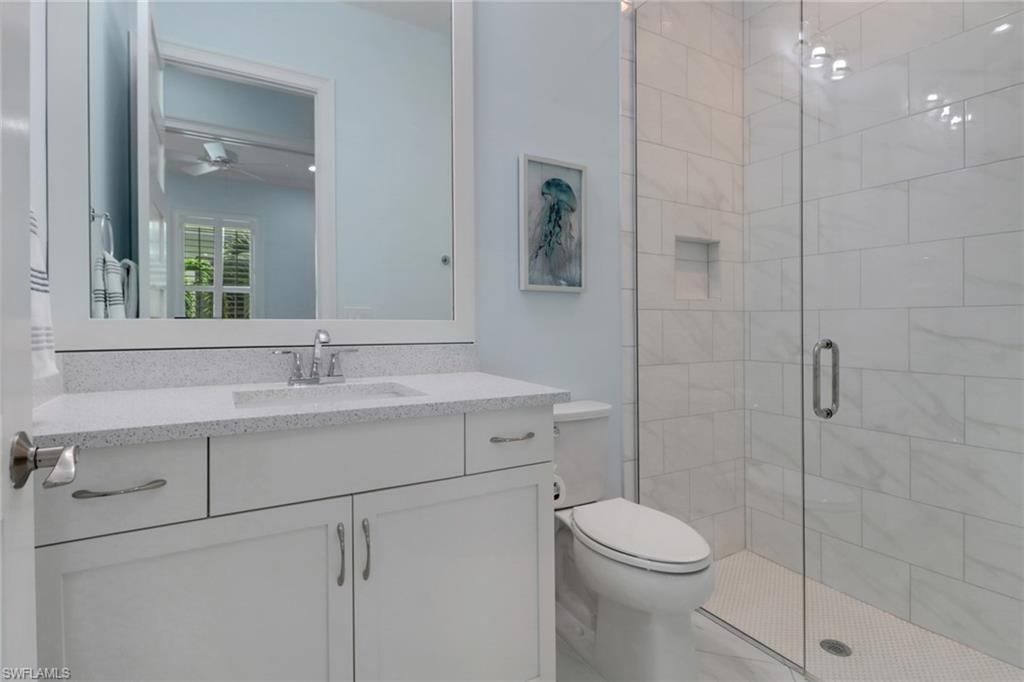 6509 Dominica Drive, Unit 101 Naples, FL 34113 - Photo 16 of 33 a bathroom with a sink a toilet and shower