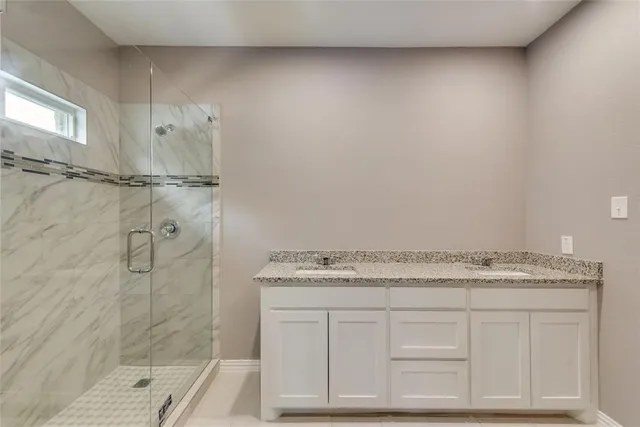 a bathroom with a granite countertop sink and vanity