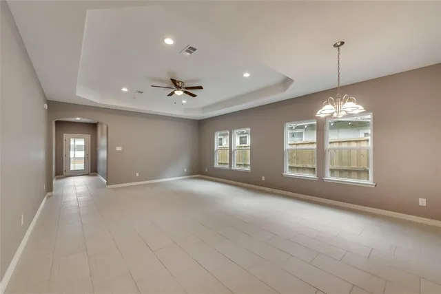 a view of a chandelier fan and entryway