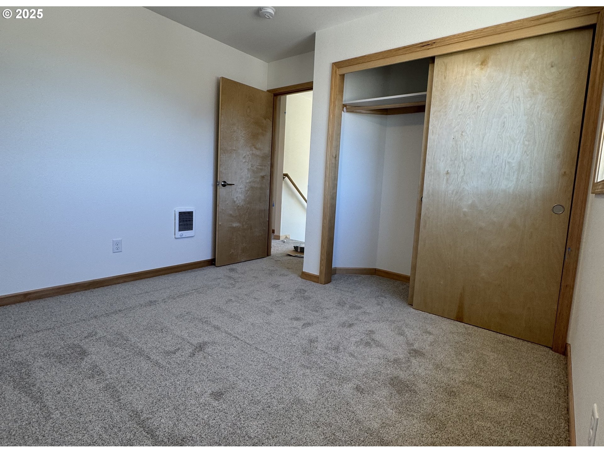 670 ST Charles Street Eugene, OR 97402 - Photo 12 of 17 an empty room with closet and wooden door