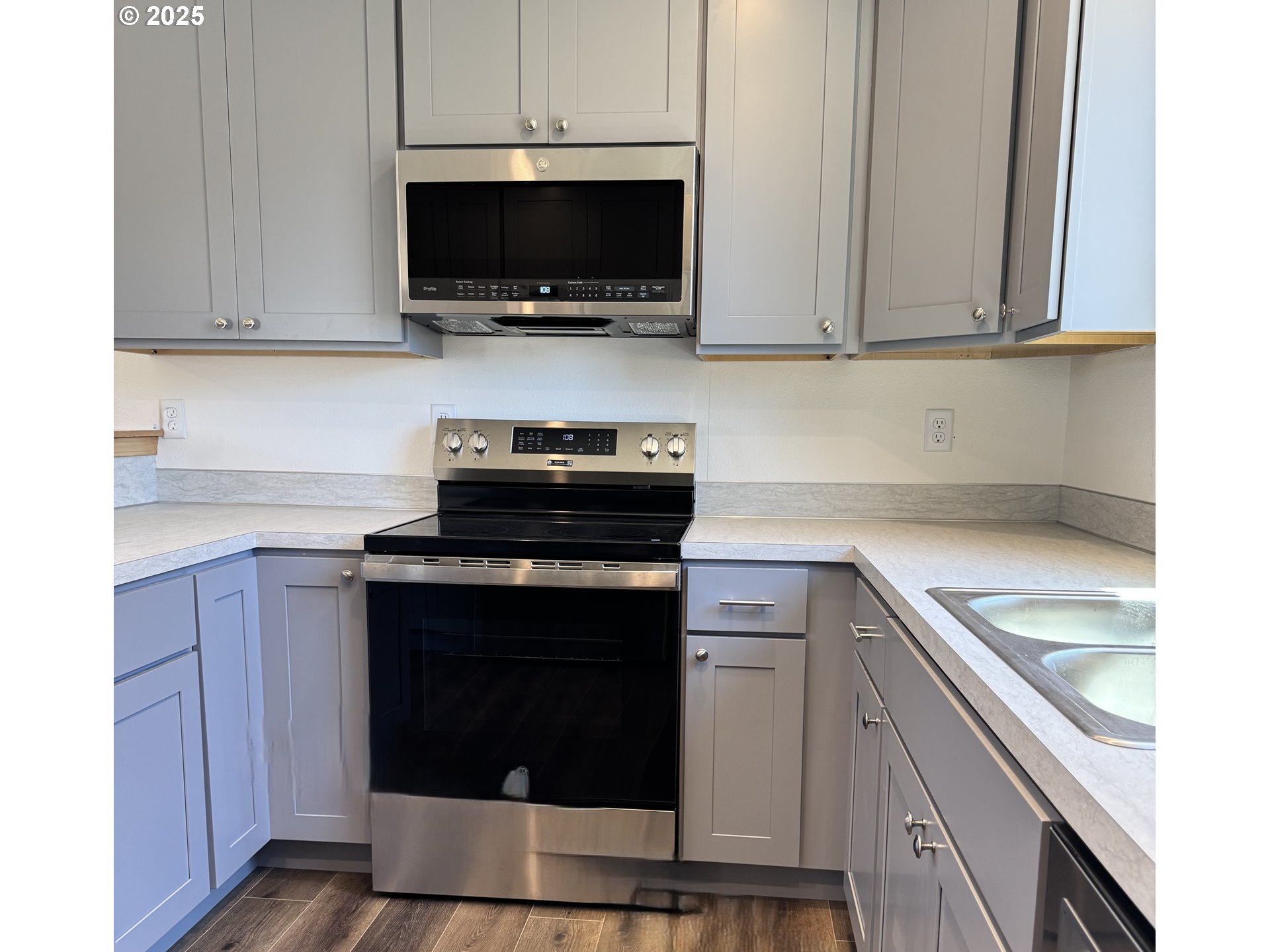 670 ST Charles Street Eugene, OR 97402 - Photo 5 of 17 a kitchen with a stove and a microwave