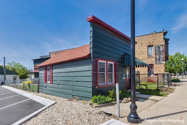 a view of a house with a small yard and plants