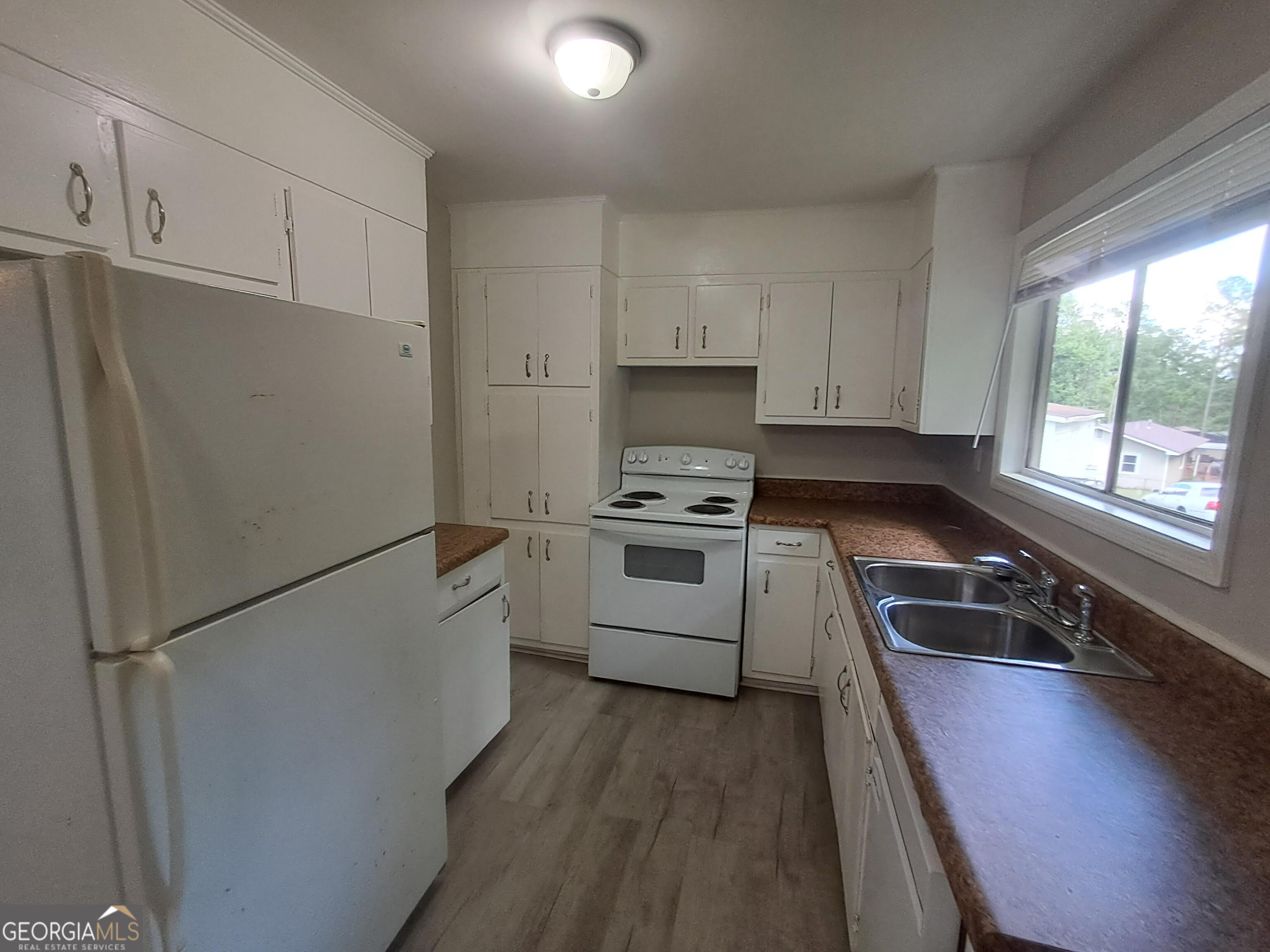 193 Frazier Drive Southeast Milledgeville, GA 31061 - Photo 14 of 38 a kitchen with a refrigerator a stove a sink and a window