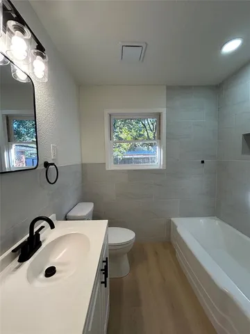 a bathroom with a toilet sink shower and mirror