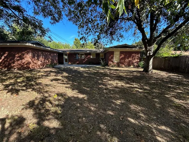 a view of a house with a tree
