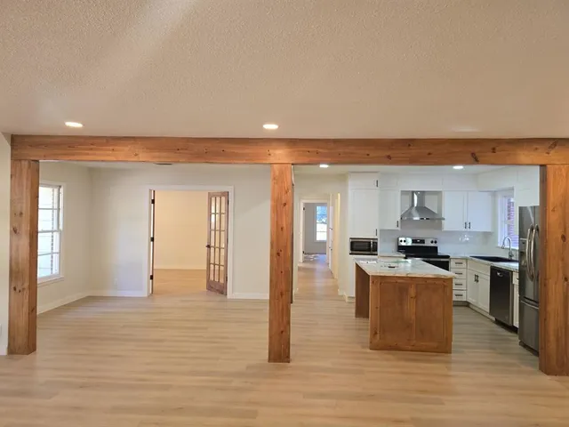 a open kitchen with cabinets and wooden floor