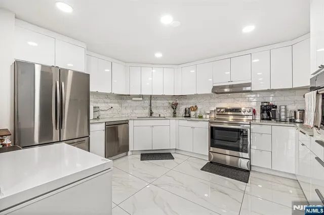 a kitchen with a white stove top oven and refrigerator