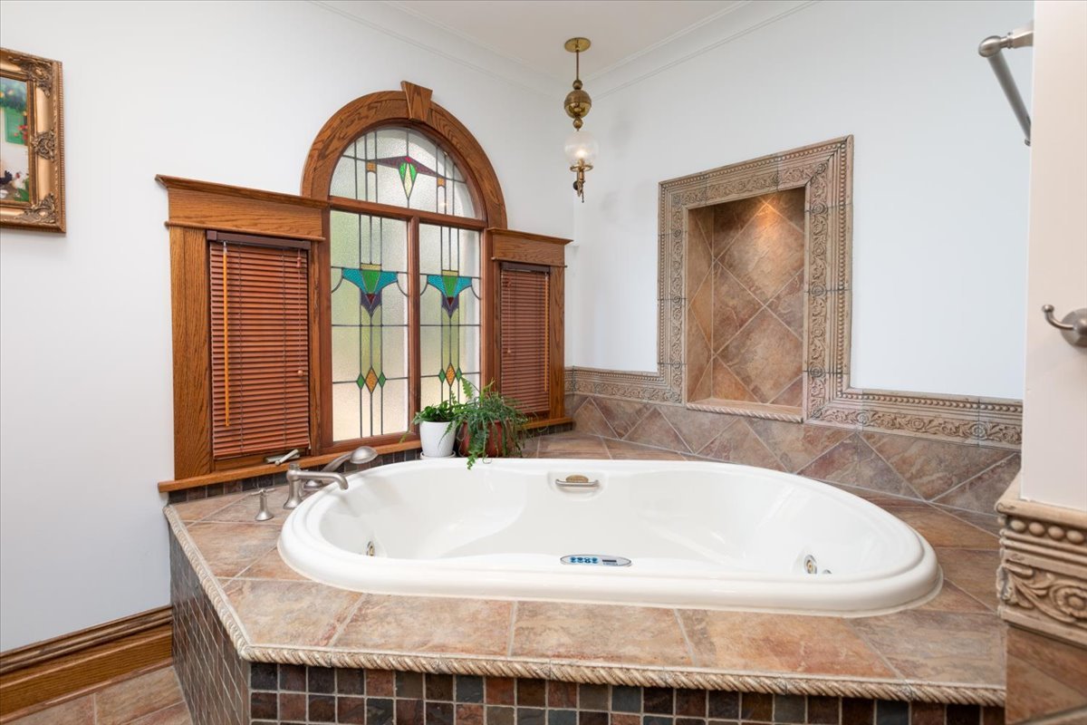 23 Columbia Street Naperville, IL 60540 - Photo 48 of 94 a bath tub sitting in a bathroom next to a window